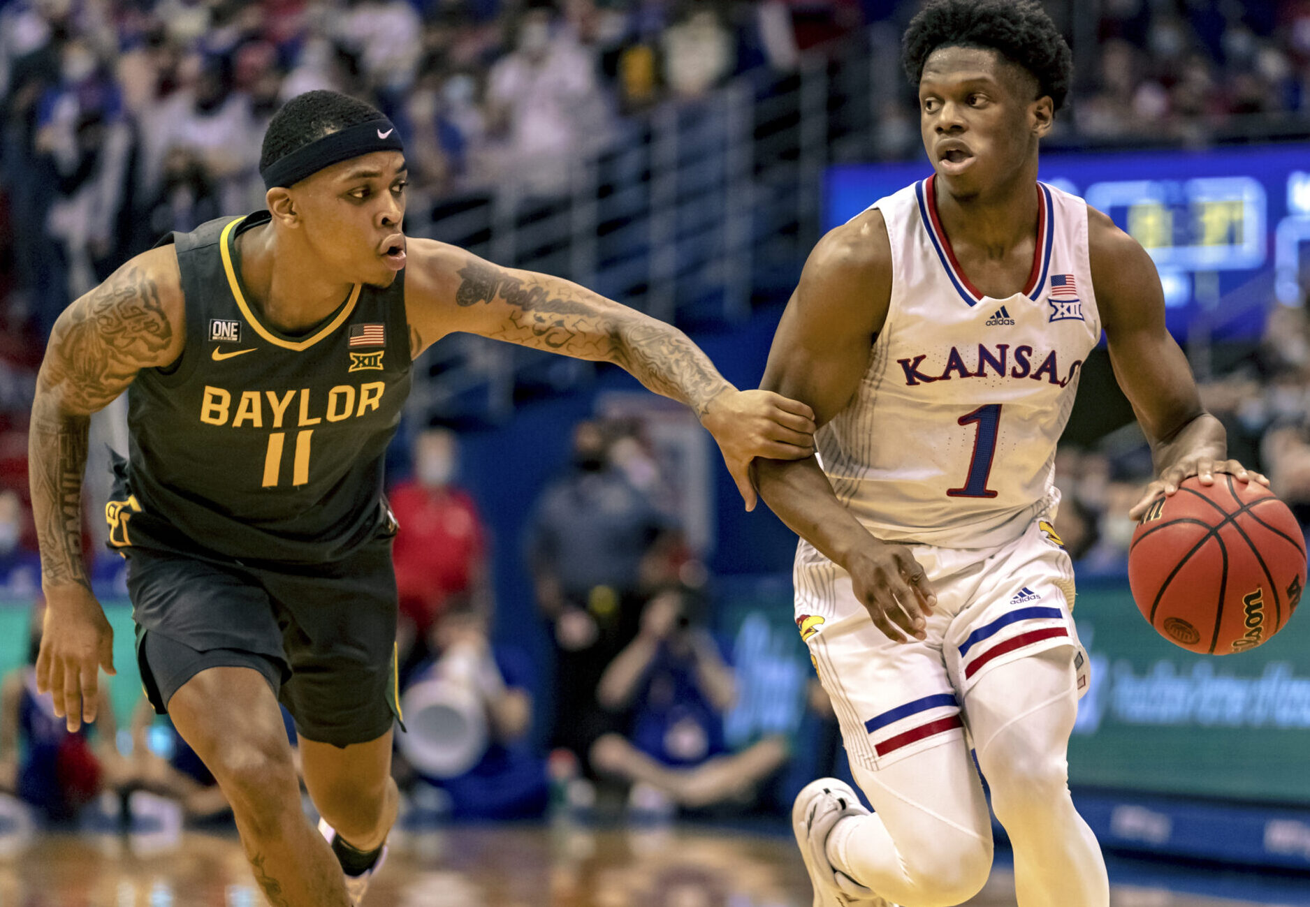 Baylor Bears guard James Akinjo (left) attempts to defend Kansas Jayhawks guard Joseph Yesufu during a Big 12 basketball game