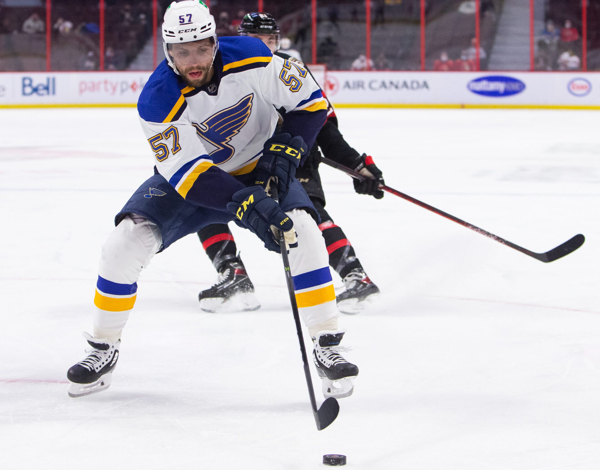 St. Louis Blues forward David Perron reaches for the puck with this stick during a game against the Ottawa Senators