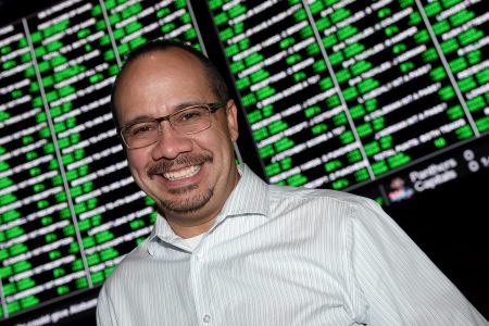 Jay Kornegay, the Vice President of Race and Sports Operations for the Westgate SuperBook, Kornegay poses in front of a video wall displaying some of the nearly 400 Super Bowl 50 proposition bets