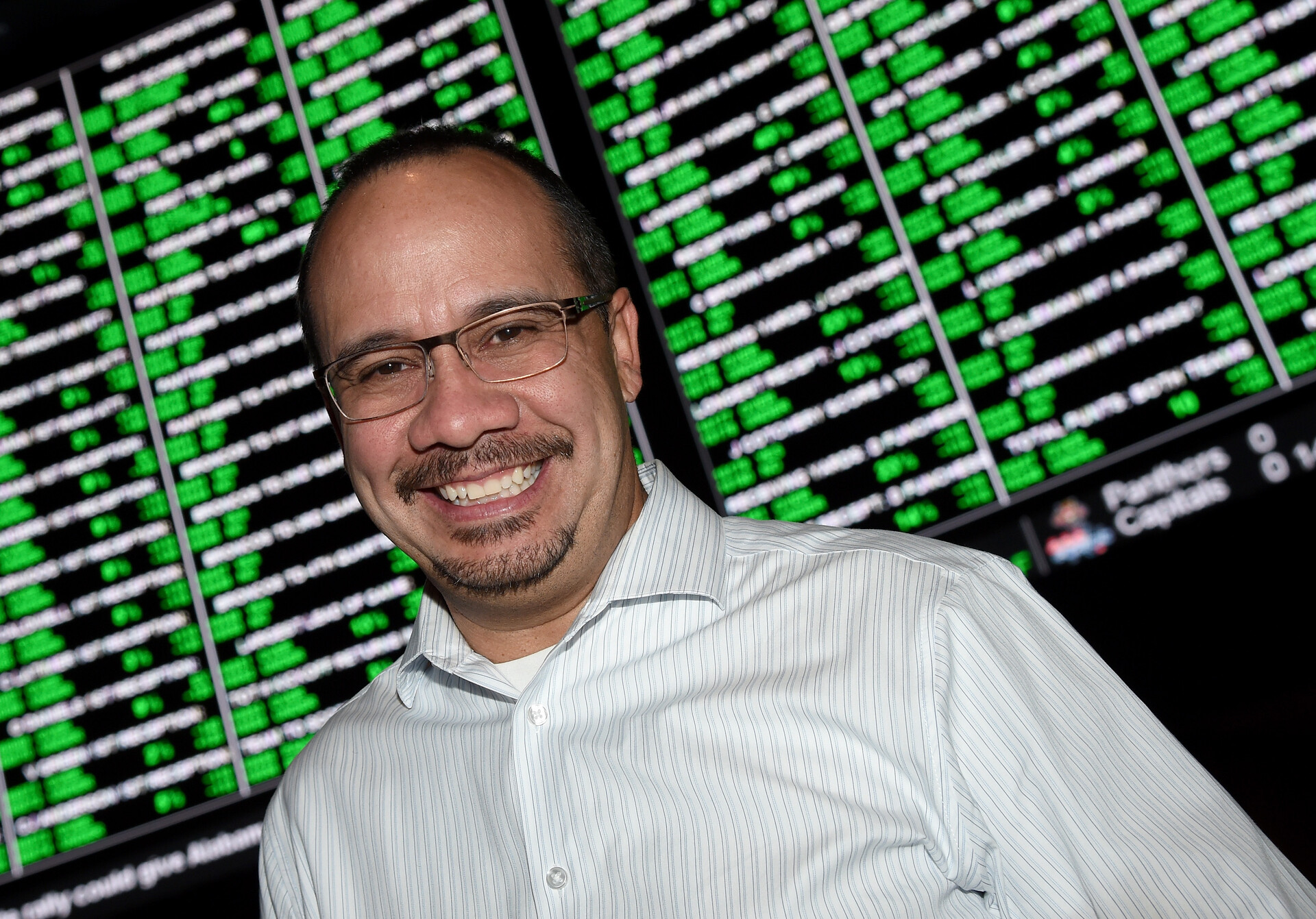 Jay Kornegay, the Vice President of Race and Sports Operations for the Westgate SuperBook, Kornegay poses in front of a video wall displaying some of the nearly 400 Super Bowl 50 proposition bets