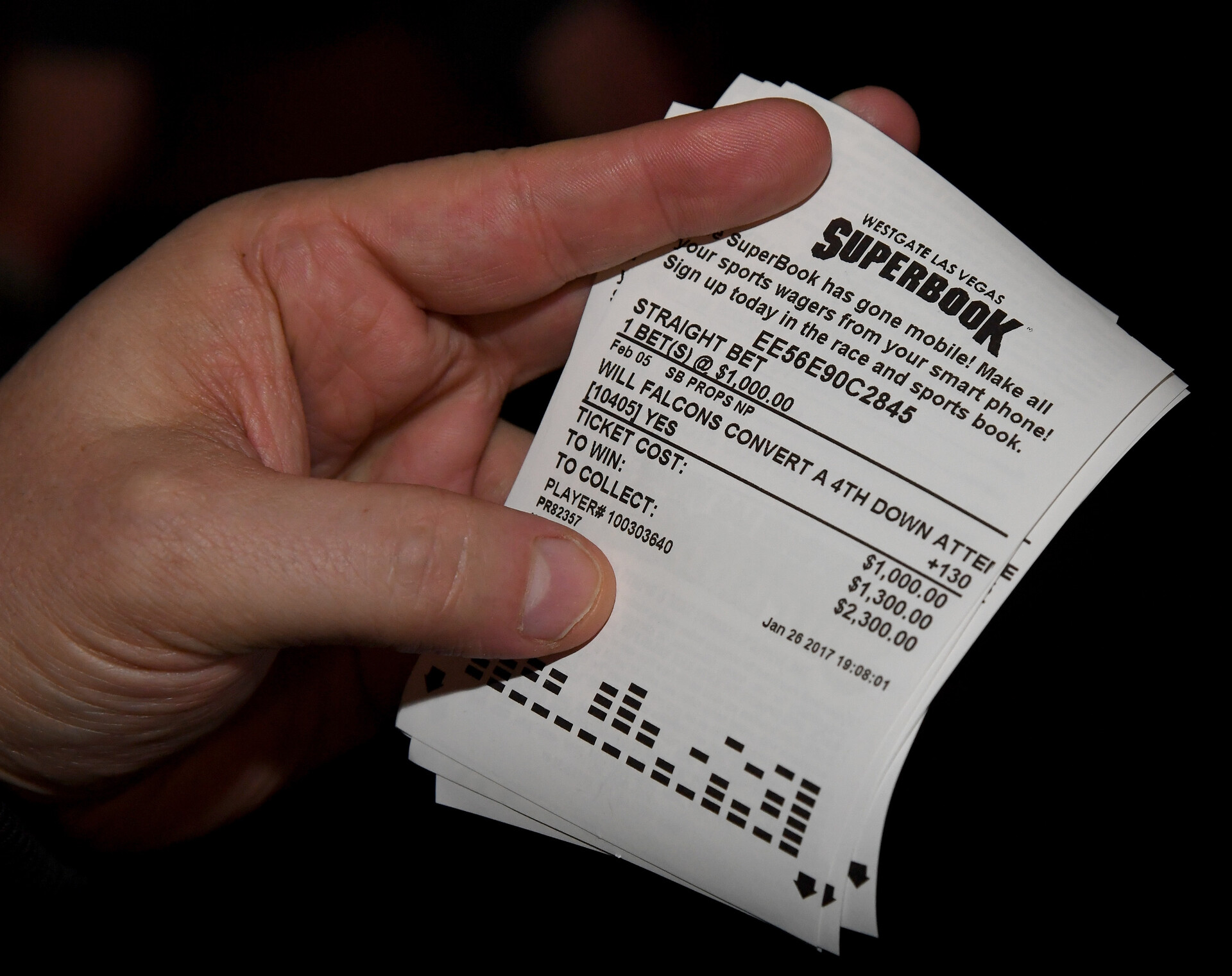 A bettor displays a betting ticket after placing wagers on some of the more than 400 proposition bets for Super Bowl LI between the Atlanta Falcons and the New England Patriots at the SuperBook at the Westgate Las Vegas