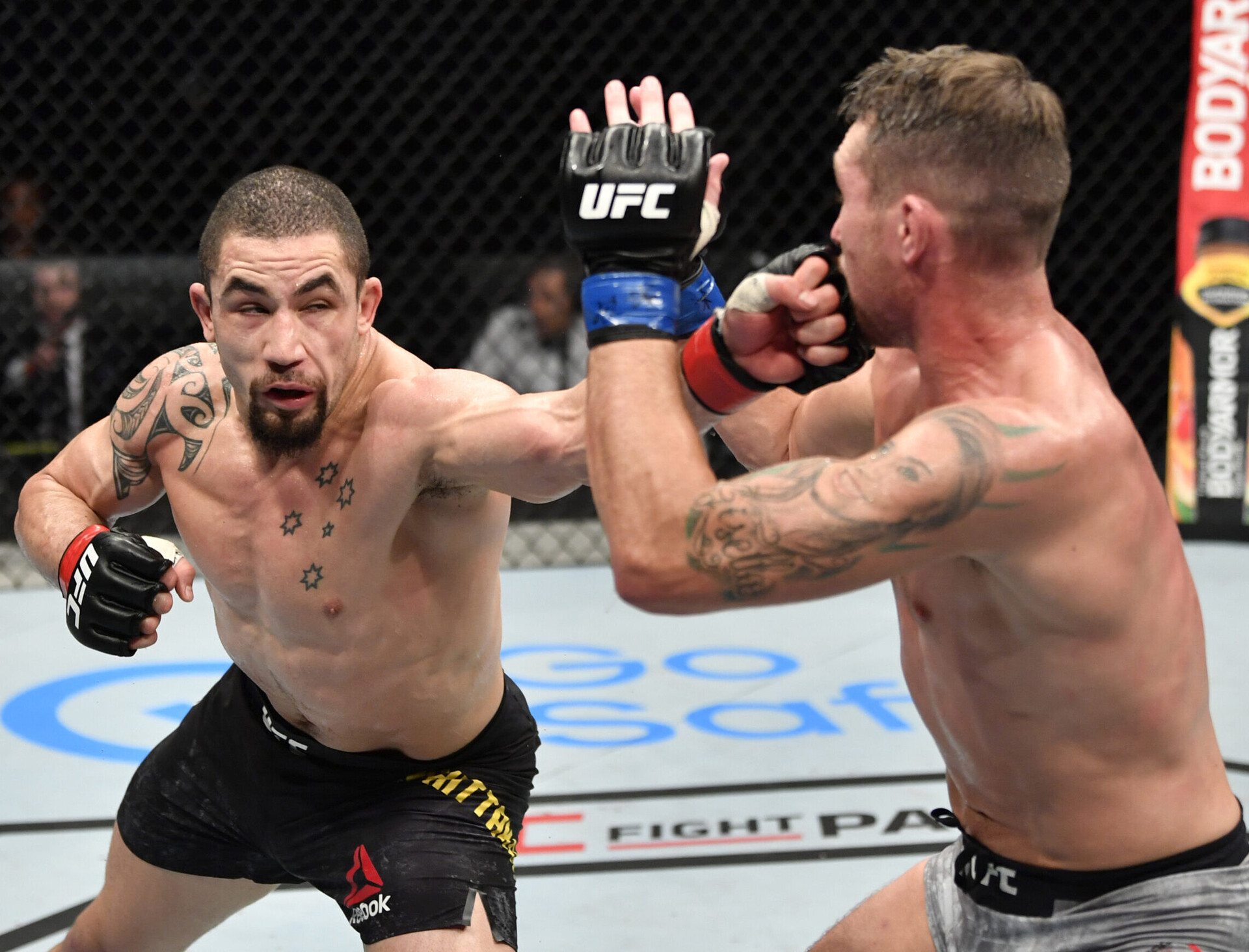 July 26, 2020; Abu Dhabi, UAE; Robert Whittaker (red gloves) of New Zealand punches Darren Till (blue gloves) of England in their middleweight fight during the UFC Fight Night event inside Flash Forum on UFC Fight Island.