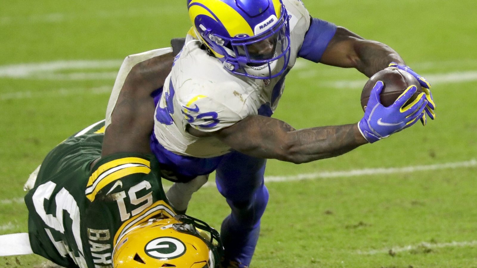 Los Angeles Rams running back Cam Akers (23) dives across the goal line against Green Bay Packers inside linebacker Krys Barnes (51) during their divisional playoff game on Saturday, January 16, 2021, at Lambeau Field in Green Bay, Wis. Apc Pack Vs Rams Div Playoff 2427 011621 Wag