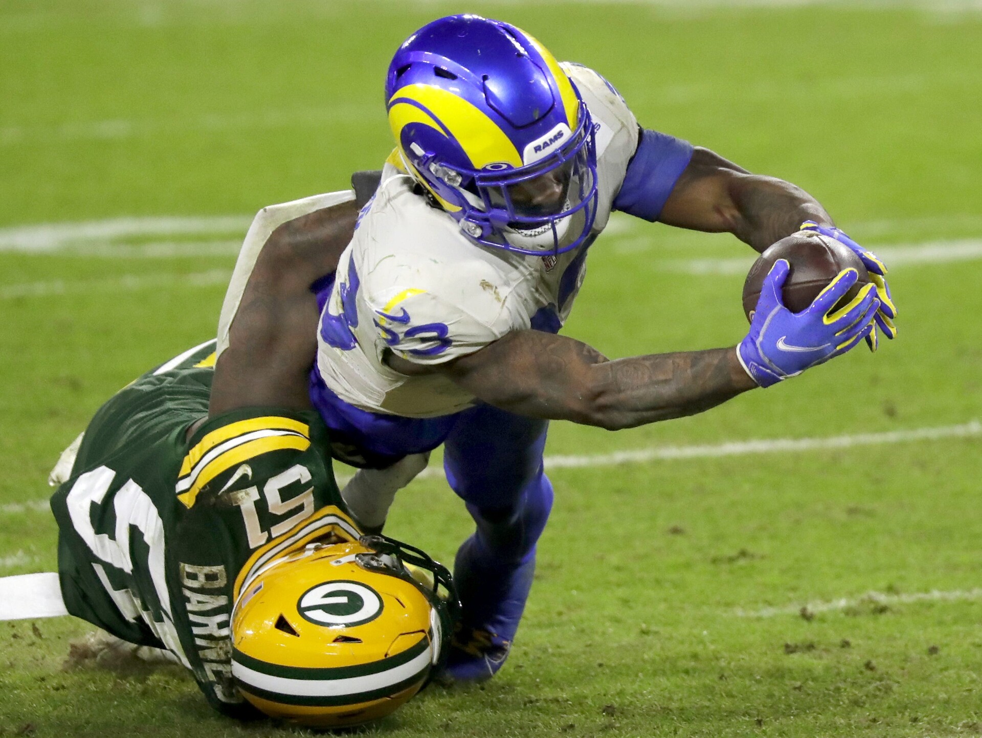 Los Angeles Rams running back Cam Akers (23) dives across the goal line against Green Bay Packers inside linebacker Krys Barnes (51) during their divisional playoff game on Saturday, January 16, 2021, at Lambeau Field in Green Bay, Wis. Apc Pack Vs Rams Div Playoff 2427 011621 Wag