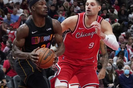 Miami Heat forward Jimmy Butler (left) starts to make a move to the basket while being defended by Chicago Bulls center Nikola Vucevic