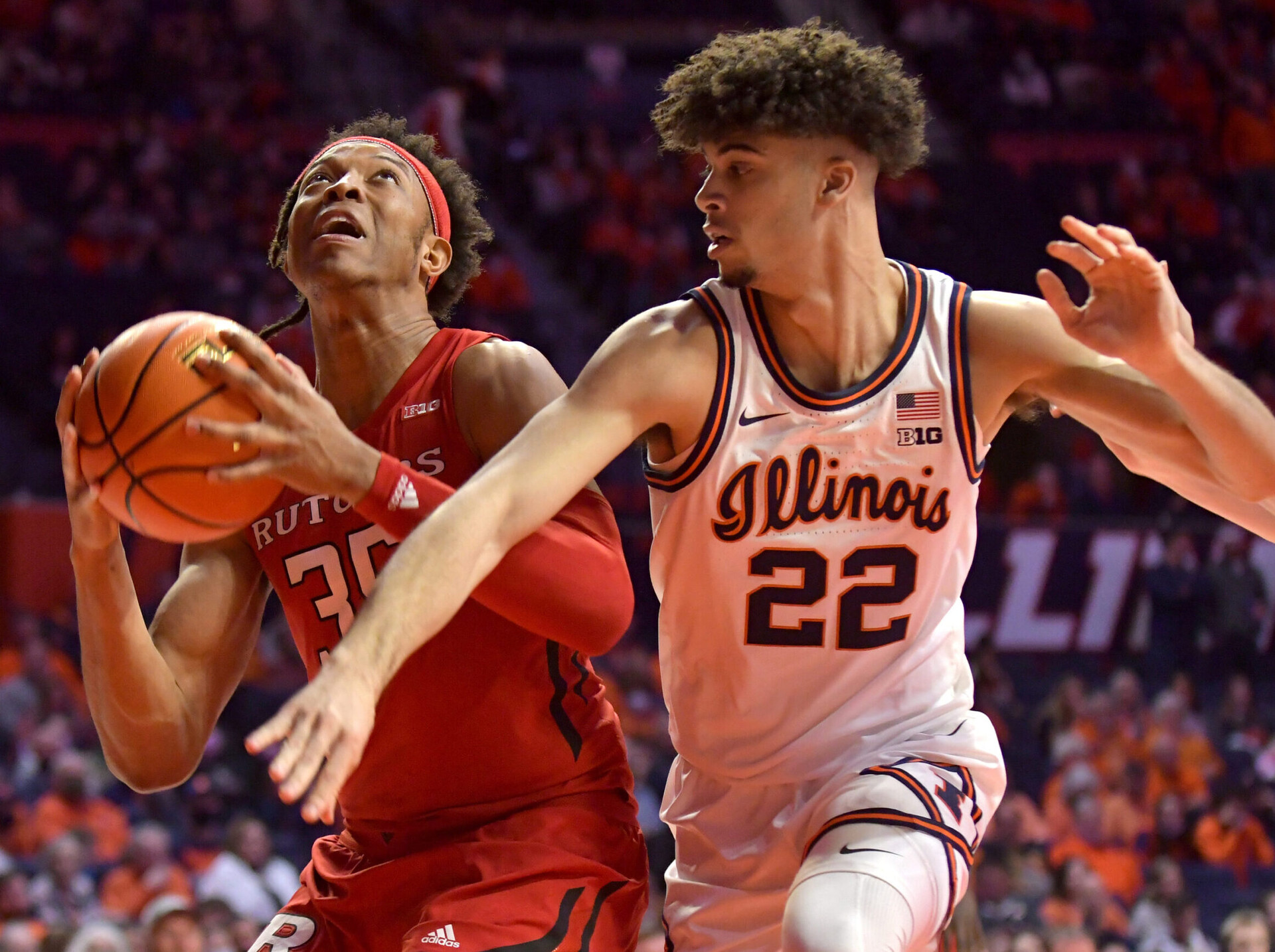 Rutgers Scarlet Knights forward Ralph Gonzales-Agee (left) drives to the basket past Illinois Fighting Illini guard Austin Hutcherson (right) during a Big Ten basketball game