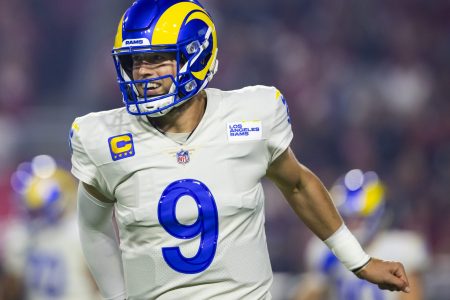 Los Angeles Rams quarterback Matthew Stafford smiles while jogging off the field during a game against the Arizona Cardinals