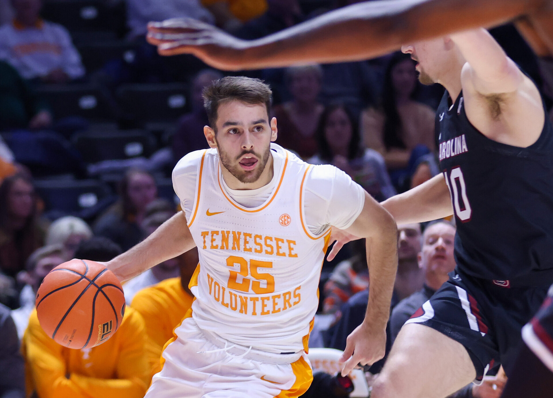Tennessee Volunteers guard Santiago Vescovi (left) dribbles the ball as he tries to maneuver around South Carolina Gamecocks guard Erik Stevenson (right) during an SEC basketball game