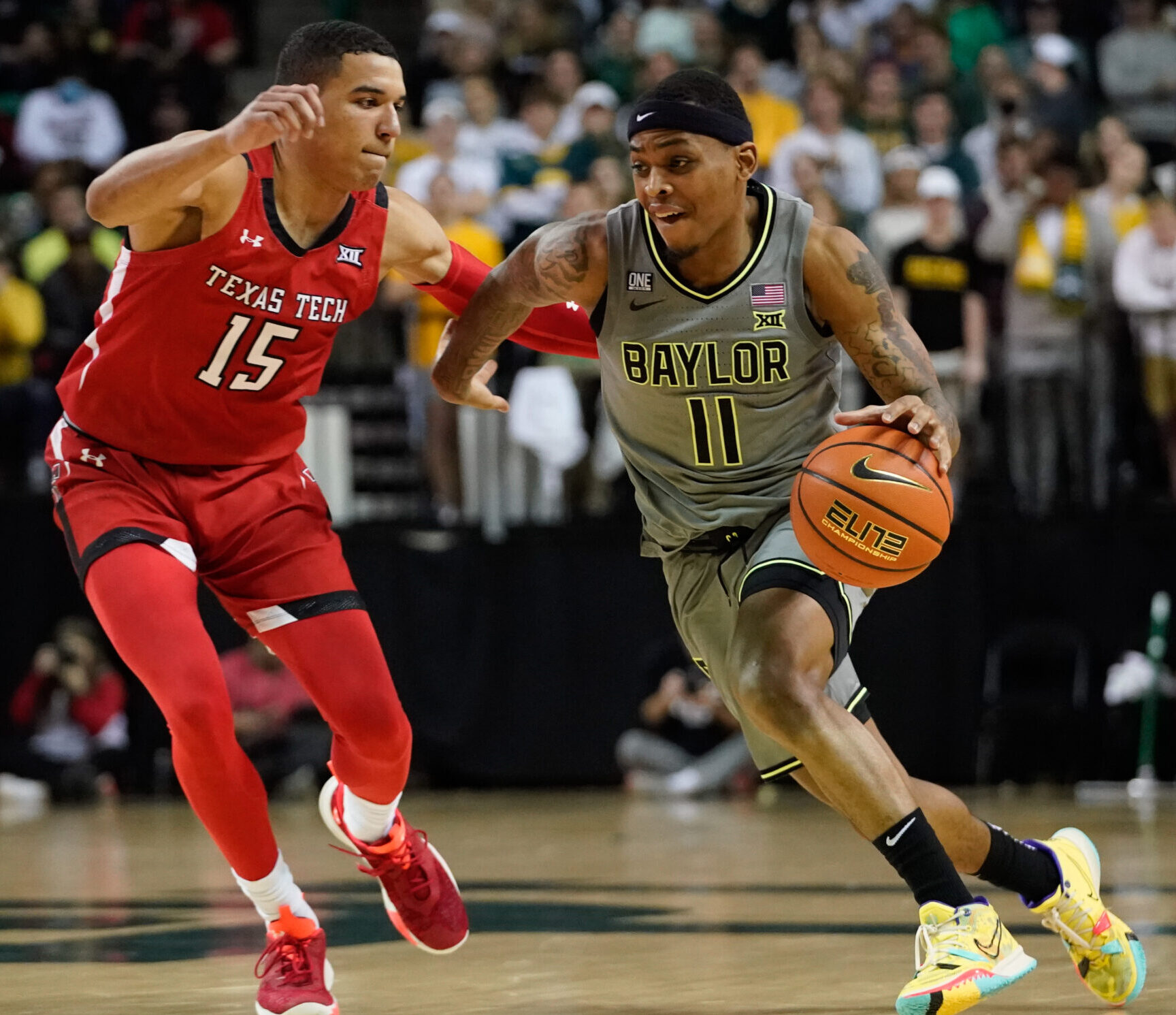 Baylor Bears guard James Akinjo (right) looks to drive to the basket while being defended by Texas Tech Red Raiders guard Kevin McCullar (left) during a Big 12 basketball game
