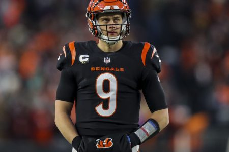 Cincinnati Bengals quarterback Joe Burrow looks on during a break in the action against the Las Vegas Raiders in an AFC Wild Card playoff football