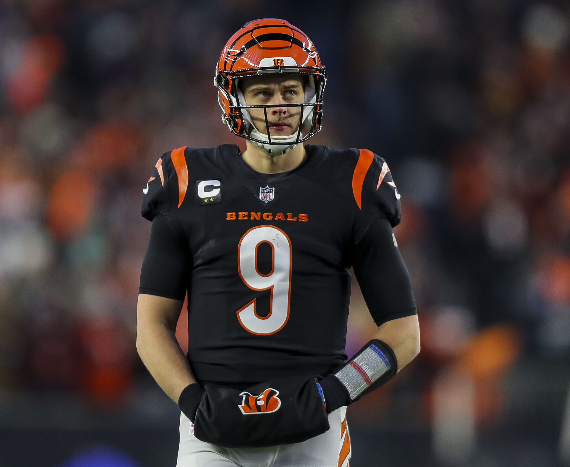 Cincinnati Bengals quarterback Joe Burrow looks on during a break in the action against the Las Vegas Raiders in an AFC Wild Card playoff football