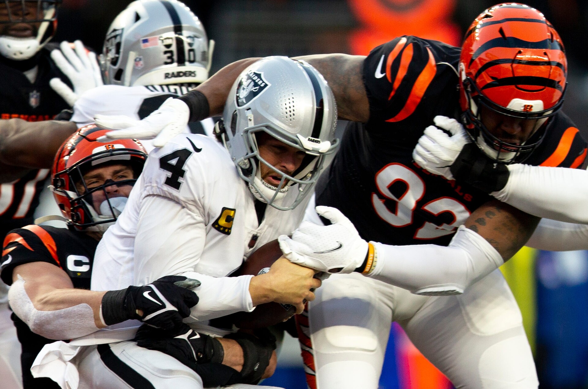 Cincinnati Bengals defensive end B.J. Hill (right) and Cincinnati Bengals defensive end Sam Hubbard (left) sack Las Vegas Raiders quarterback Derek Carr during an AFC wild card game