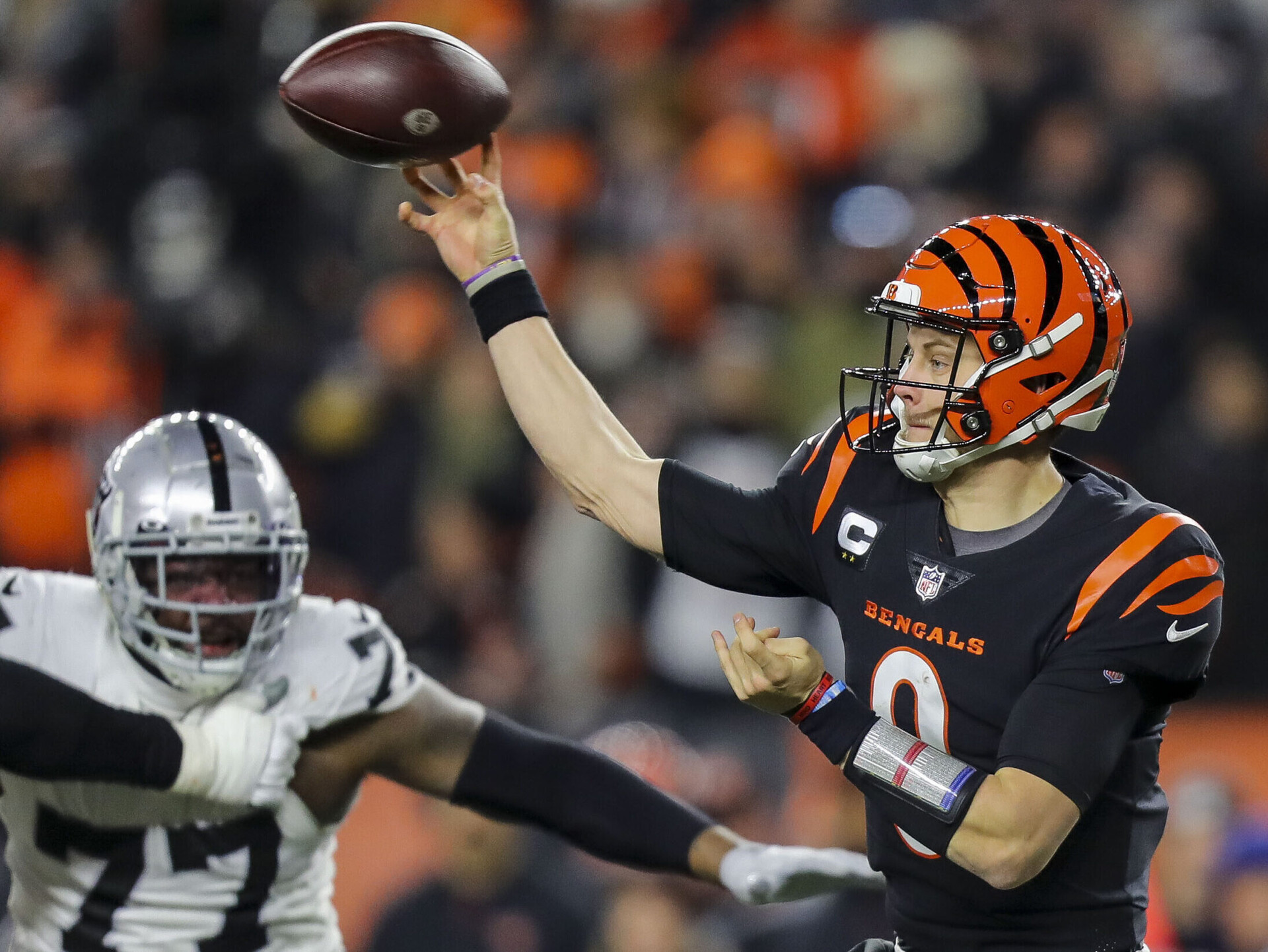 Cincinnati Bengals quarterback Joe Burrow throws a pass against the Las Vegas Raiders in the second half in an AFC Wild Card playoff football game