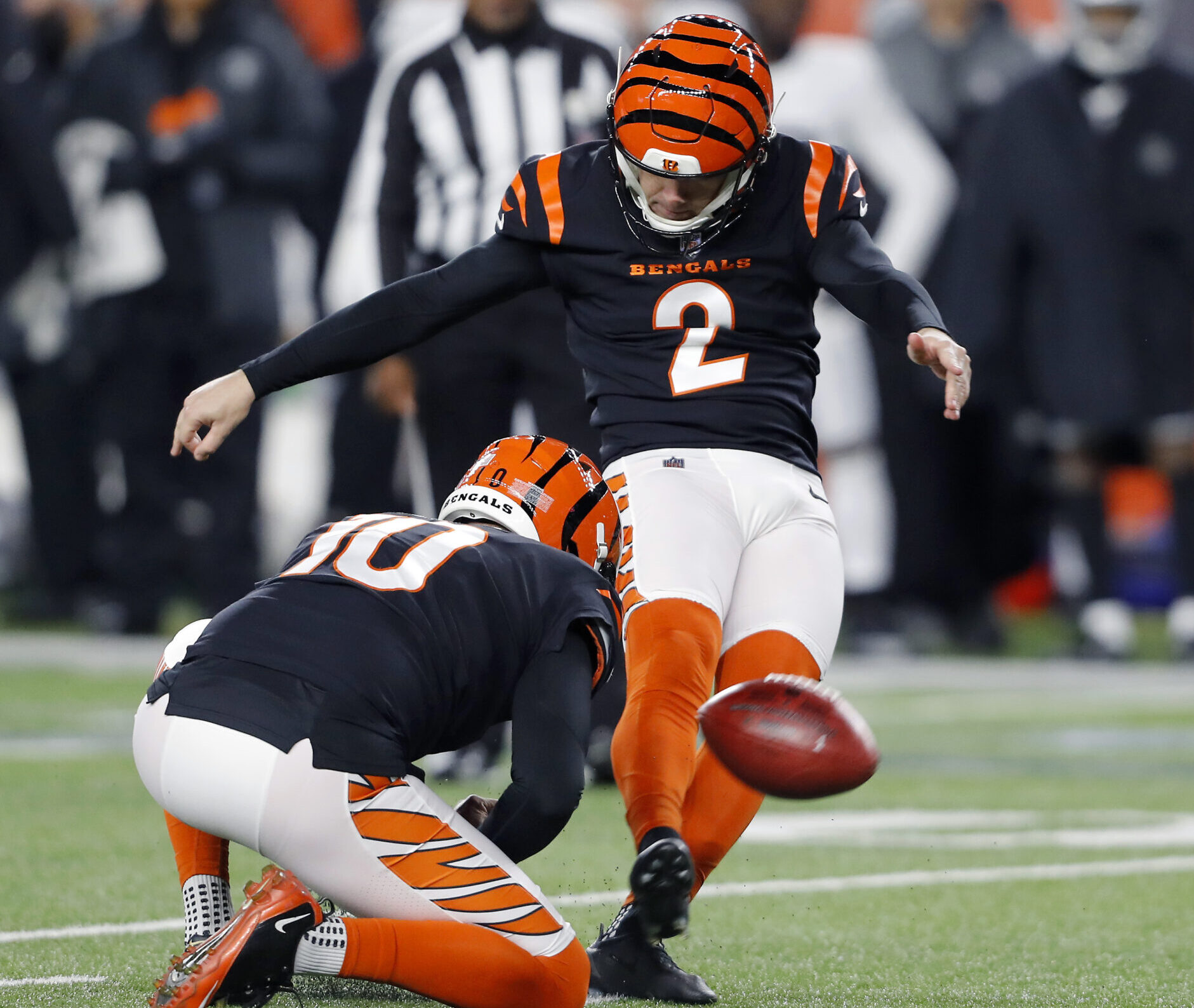 Cincinnati Bengals kicker Evan McPherson (2) kicks a field goal as punter Kevin Huber (10) holds during the fourth quarter in the AFC Wild Card playoff football game against the Las Vegas Raiders