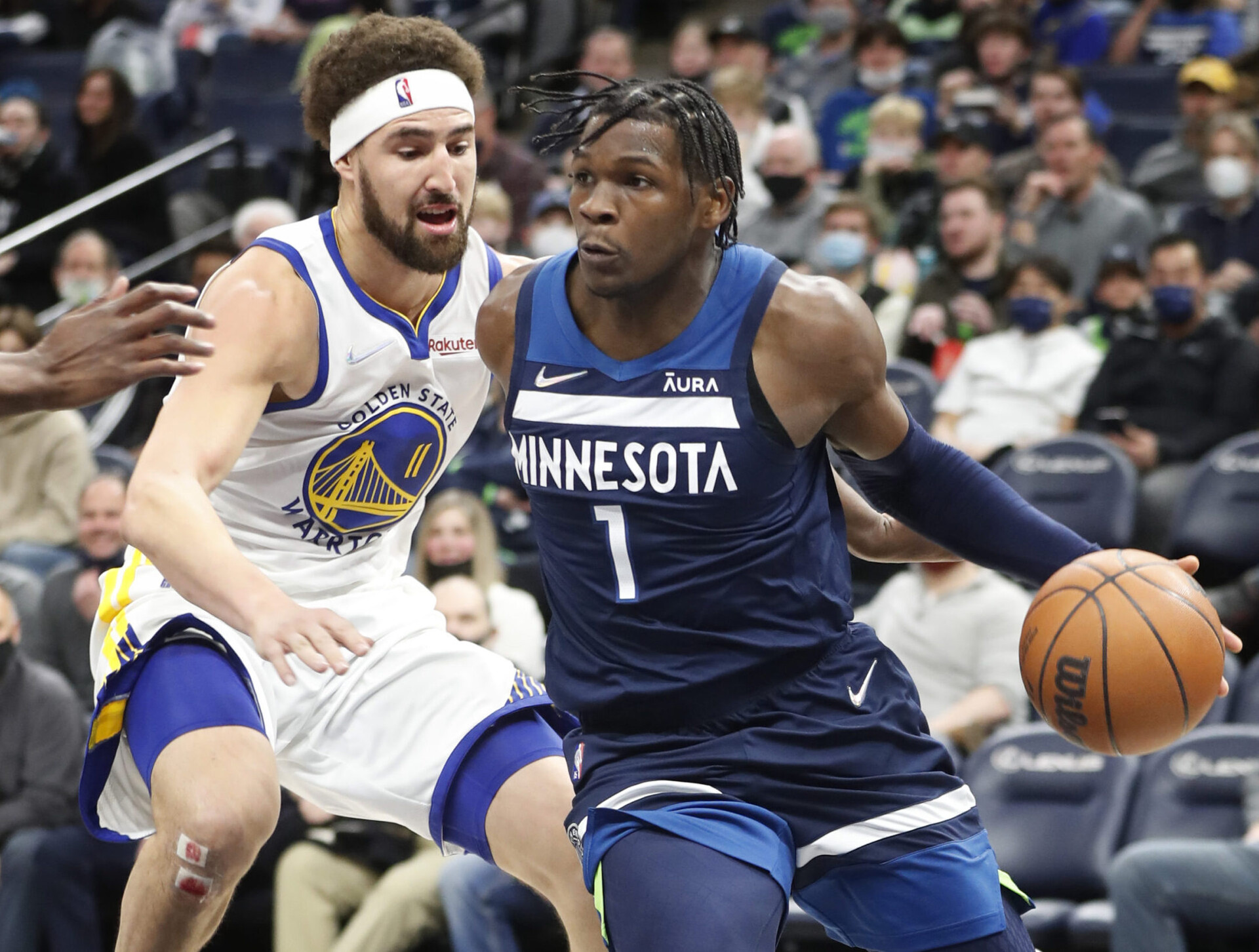 Minnesota Timberwolves forward Anthony Edwards (right) tries to dribble past Golden State Warriors guard Klay Thompson (left)