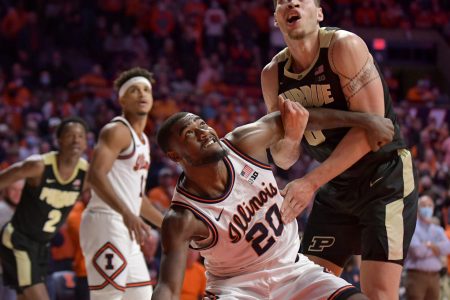Illinois Fighting Illini guard Da'Monte Williams (left) and Purdue Boilermakers forward Mason Gillis (right) battle for position under the basket during a Big Ten basketball game