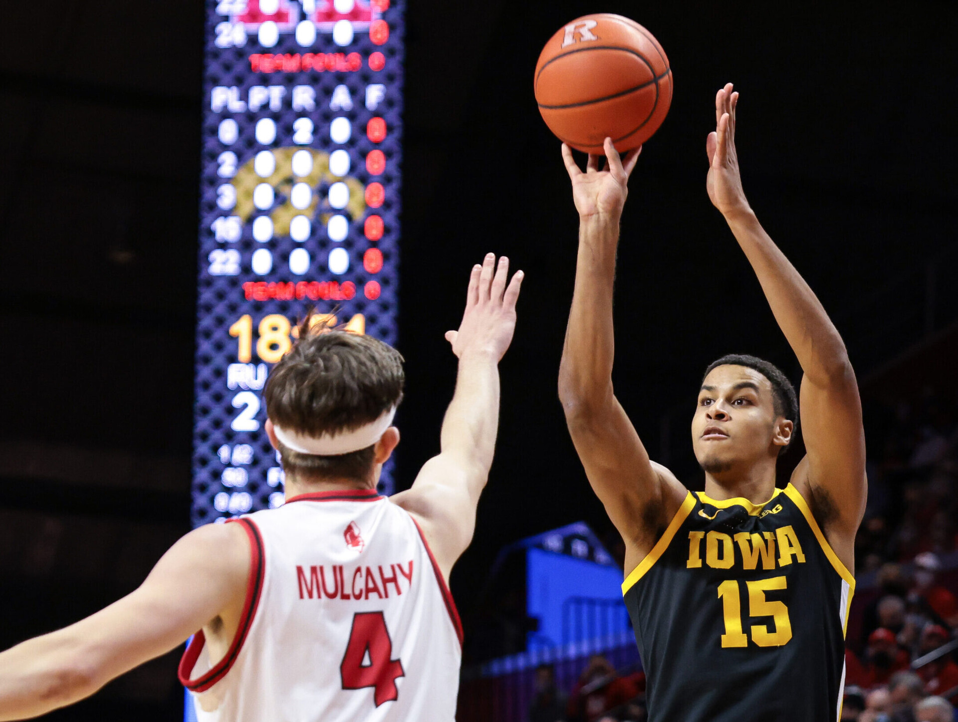 Iowa Hawkeyes forward Keegan Murray (left) shoots the ball over Rutgers Scarlet Knights guard Paul Mulcahy (right) during a Big Ten basketball game