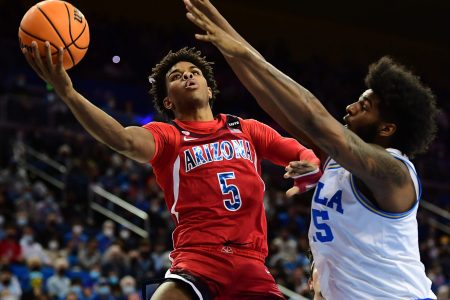 Arizona Wildcats guard Justin Kier (left) rises to take a shot while UCLA Bruins center Myles Johnson (right) defends during a Pac-12 Conference basketball game at UCLA