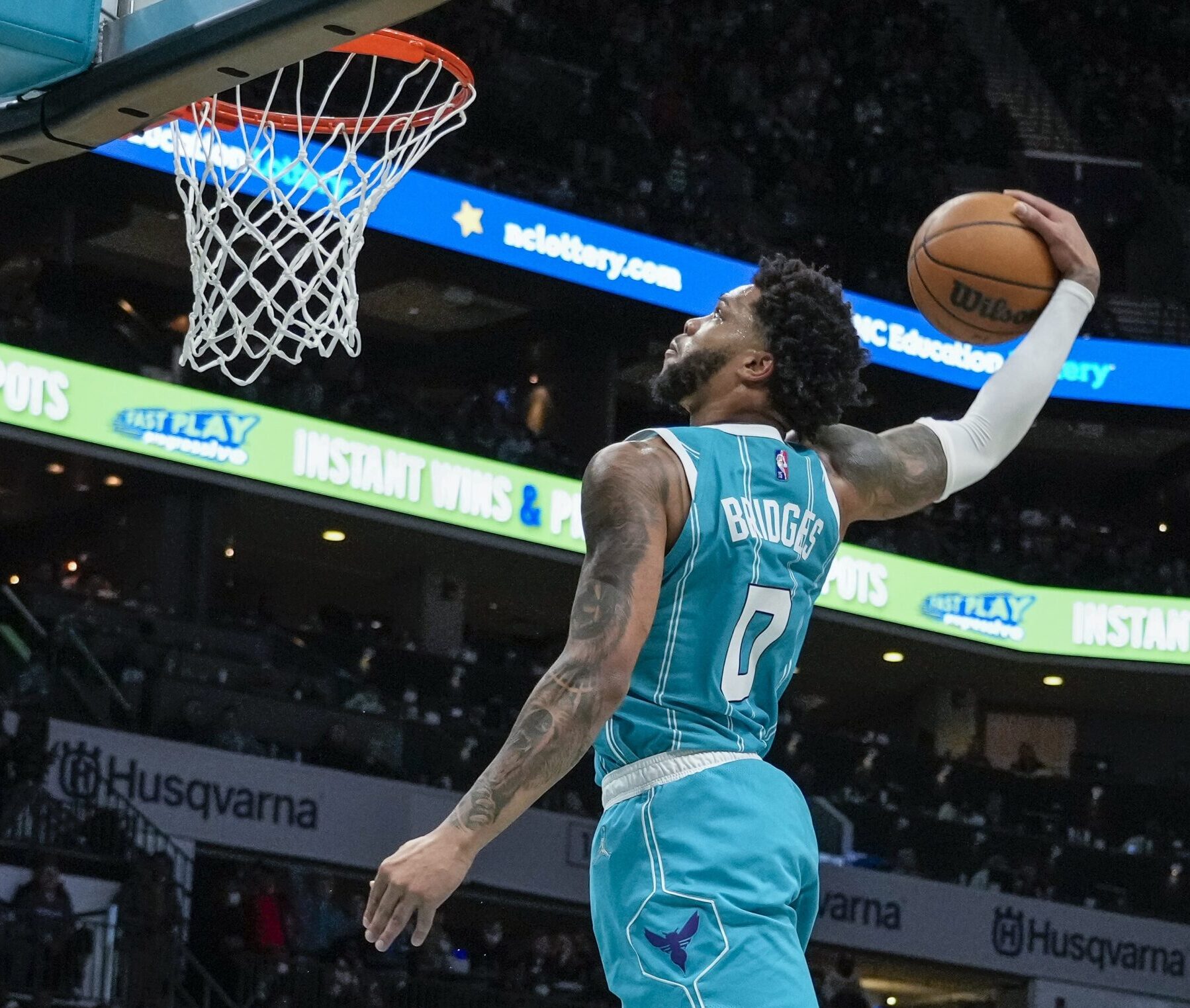 Charlotte Hornets forward Miles Bridges leaps in the air and prepares to dunk the basketball during a game against the Los Angeles Lakers