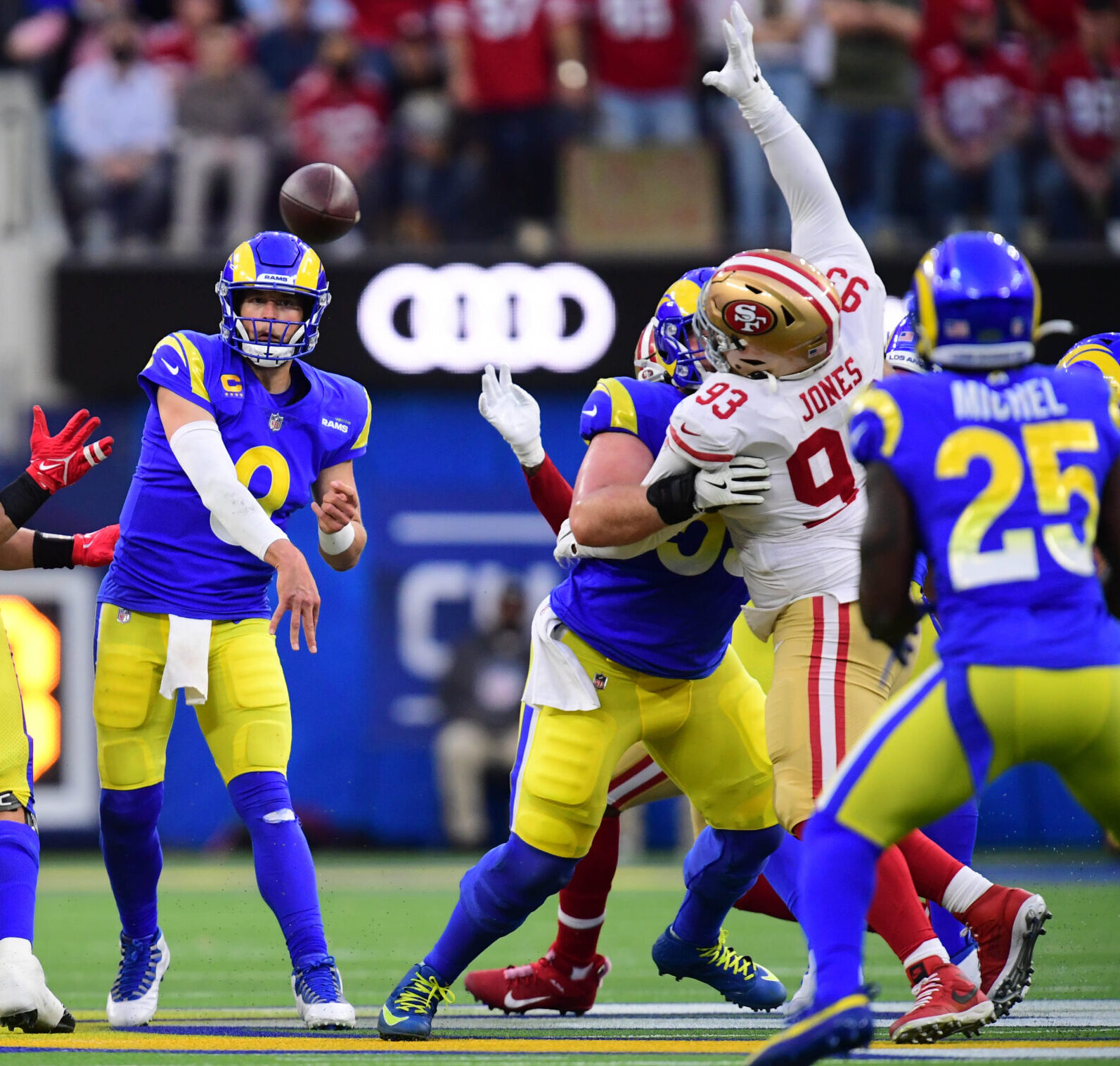 Los Angeles Rams quarterback Matthew Stafford (center) throws a pass against the San Francisco 49ers in the first half of the NFC Championship Game