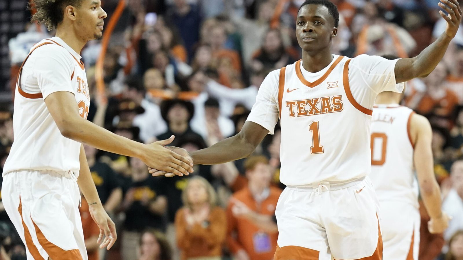Texas Longhorns guard Andrew Jones (right) congratulated by forward Tre Mitchell (left) after scoring a three-point basket during a Big 12 conference game against the Iowa State Cyclones