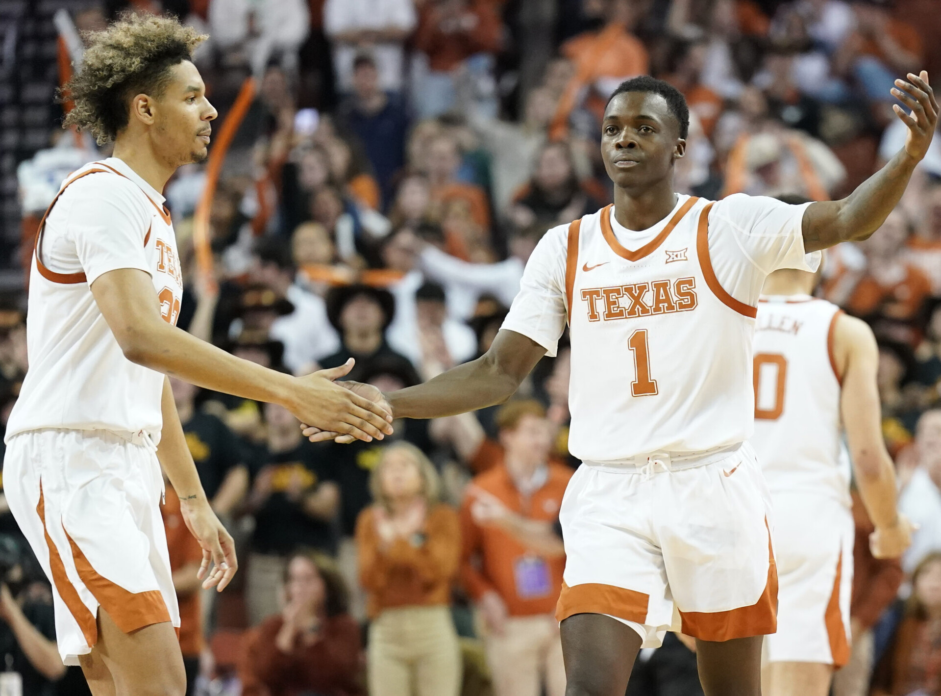 Texas Longhorns guard Andrew Jones (right) congratulated by forward Tre Mitchell (left) after scoring a three-point basket during a Big 12 conference game against the Iowa State Cyclones