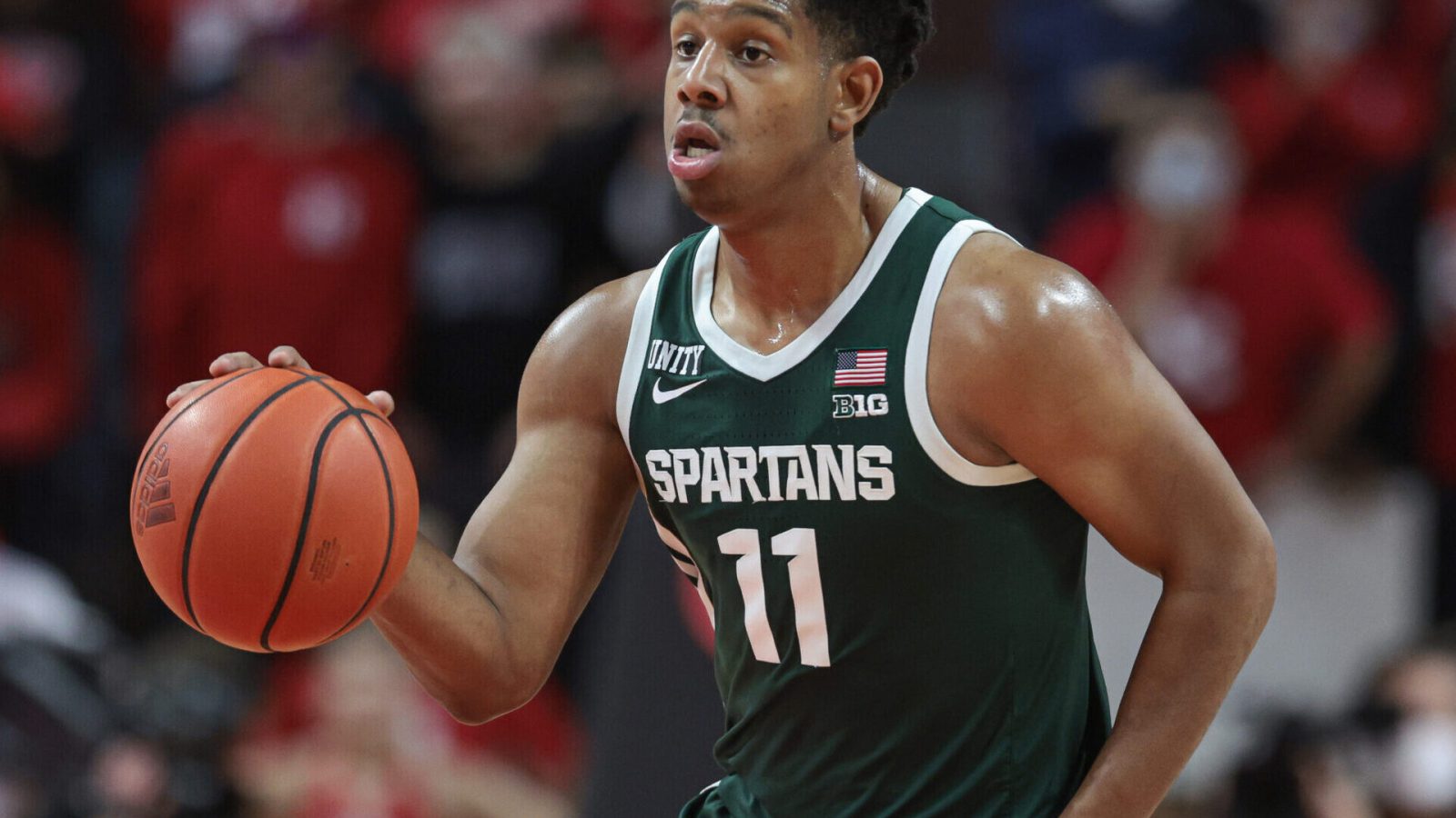 Michigan State Spartans guard A.J. Hoggard dribbles up court against the Rutgers Scarlet Knights during a Big Ten basketball game
