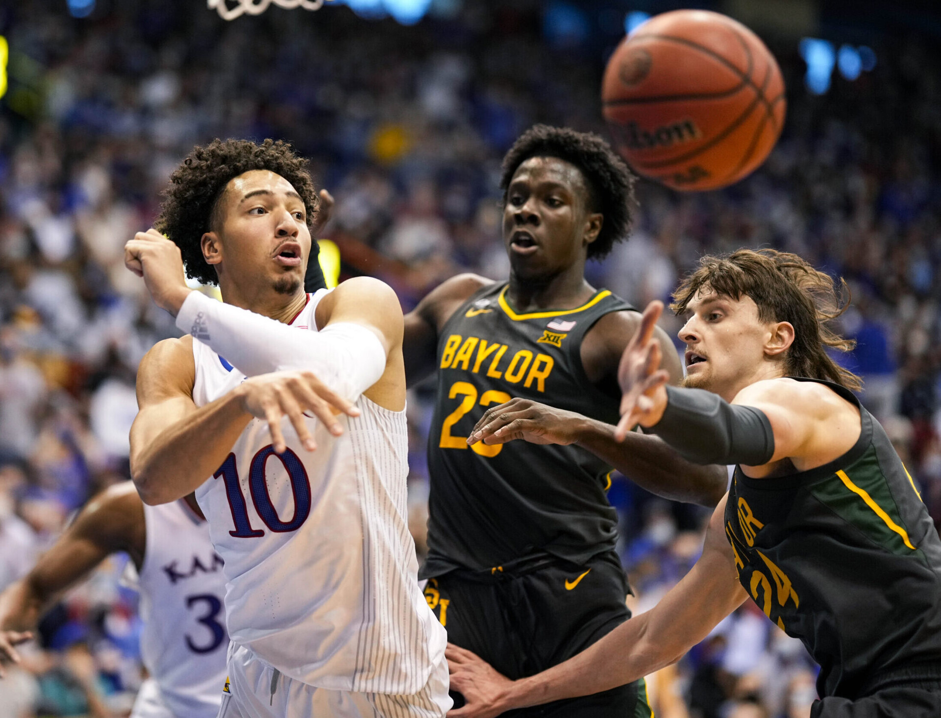 Kansas Jayhawks forward Jalen Wilson (left) loses control of the ball while being defended by Baylor Bears forward Jonathan Tchamwa Tchatchoua (center) and guard Matthew Mayer (right) during a Big 12 basketball game