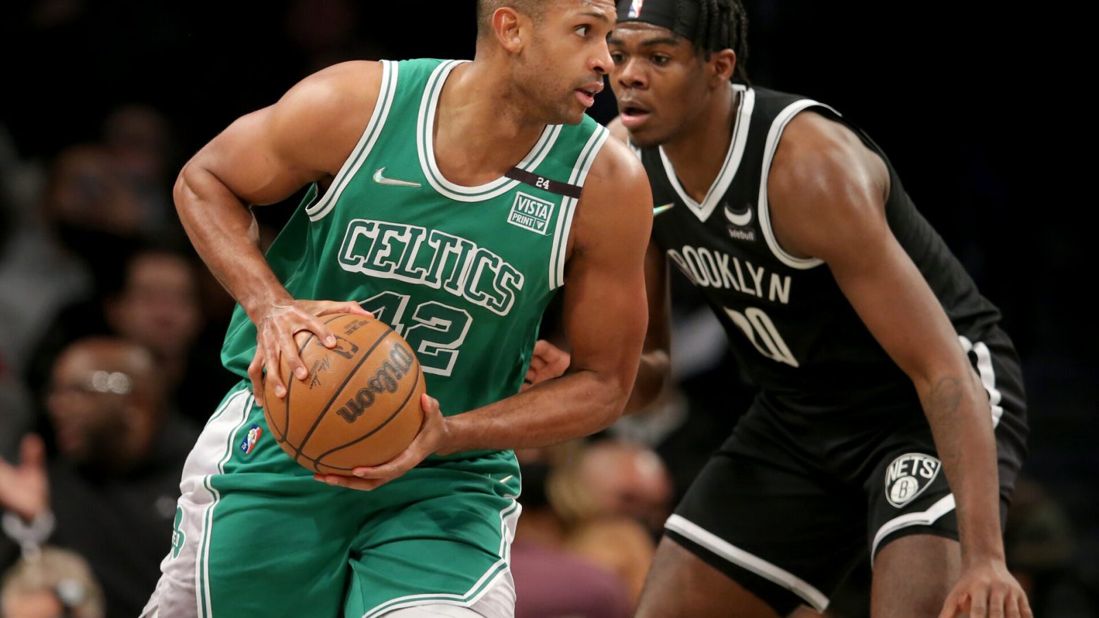 Boston Celtics center Al Horford (left) controls the ball against Brooklyn Nets center Day'Ron Sharpe (right)