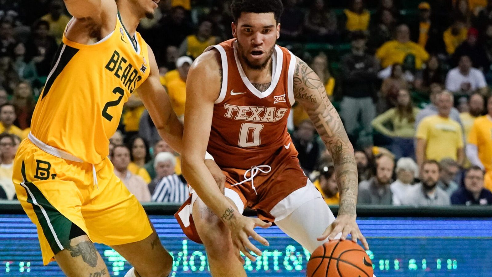 Texas Longhorns forward Timmy Allen (right) moves to the basket against Baylor Bears guard Kendall Brown (left) during a Big 12 basketball game