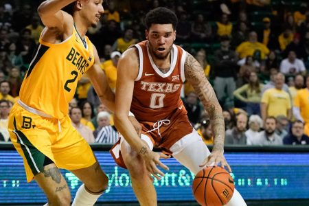 Texas Longhorns forward Timmy Allen (right) moves to the basket against Baylor Bears guard Kendall Brown (left) during a Big 12 basketball game