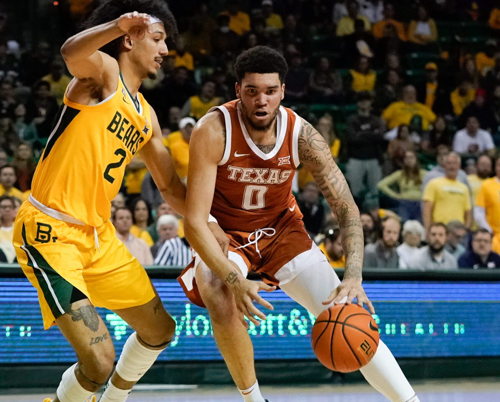 Texas Longhorns forward Timmy Allen (right) moves to the basket against Baylor Bears guard Kendall Brown (left) during a Big 12 basketball game