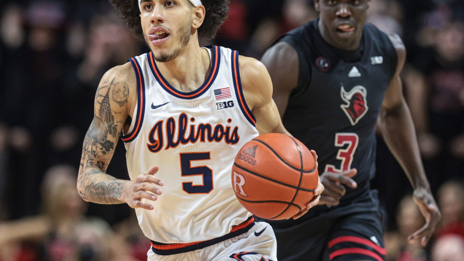 Illinois Fighting Illini guard Andre Curbelo (left) dribbles up court in front of Rutgers Scarlet Knights forward Mawot Mag (right) during a Big Ten basketball game