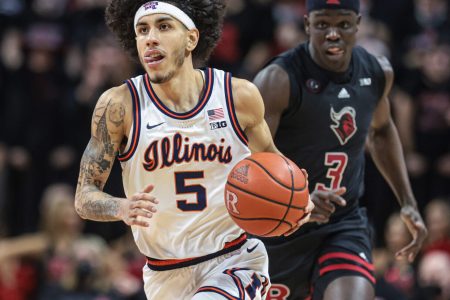 Illinois Fighting Illini guard Andre Curbelo (left) dribbles up court in front of Rutgers Scarlet Knights forward Mawot Mag (right) during a Big Ten basketball game