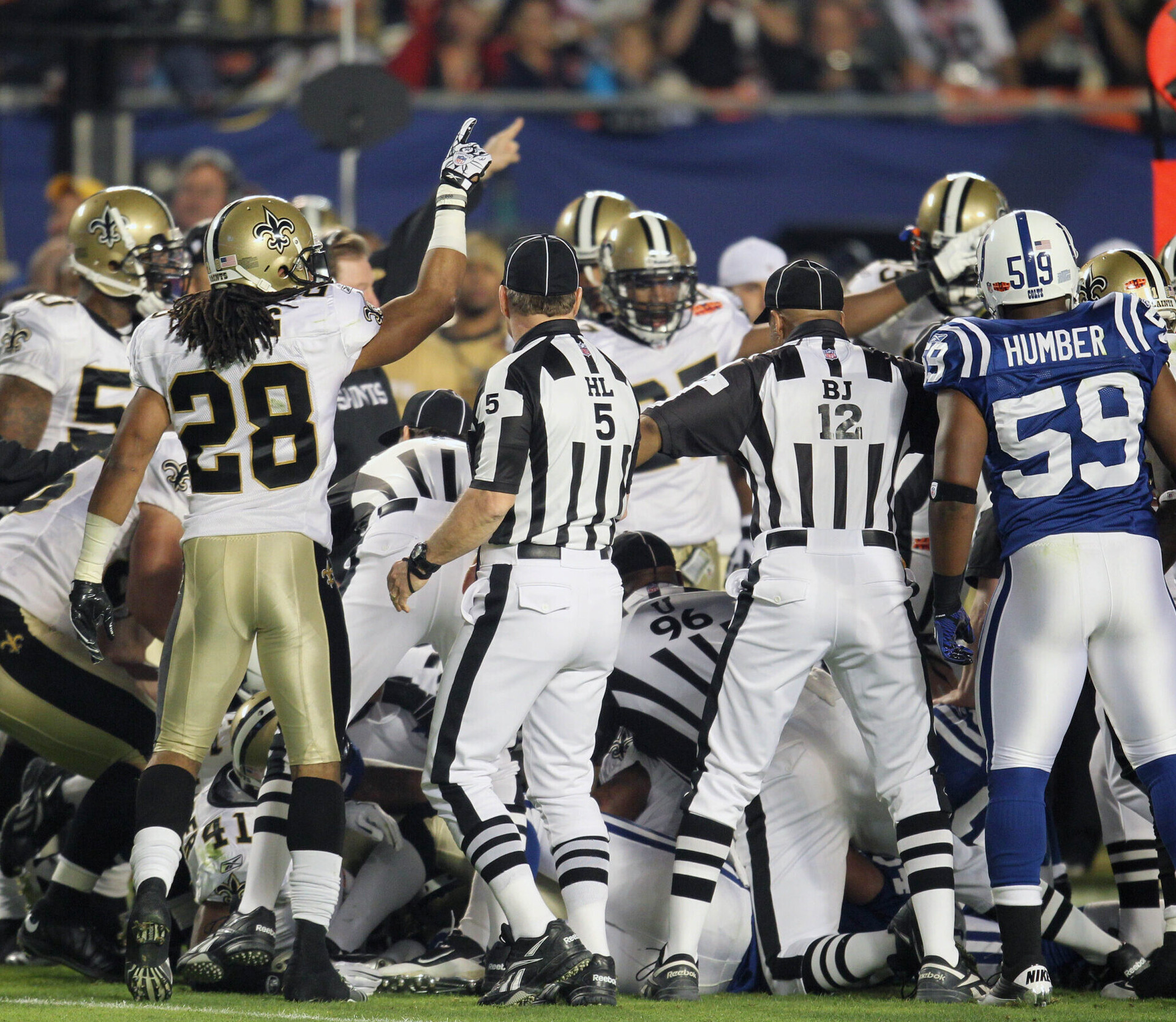 New Orleans Saints players in white fight for the ball after an onside kick during the third quarter of Super Bowl XLIV against the Indianapolis Colts