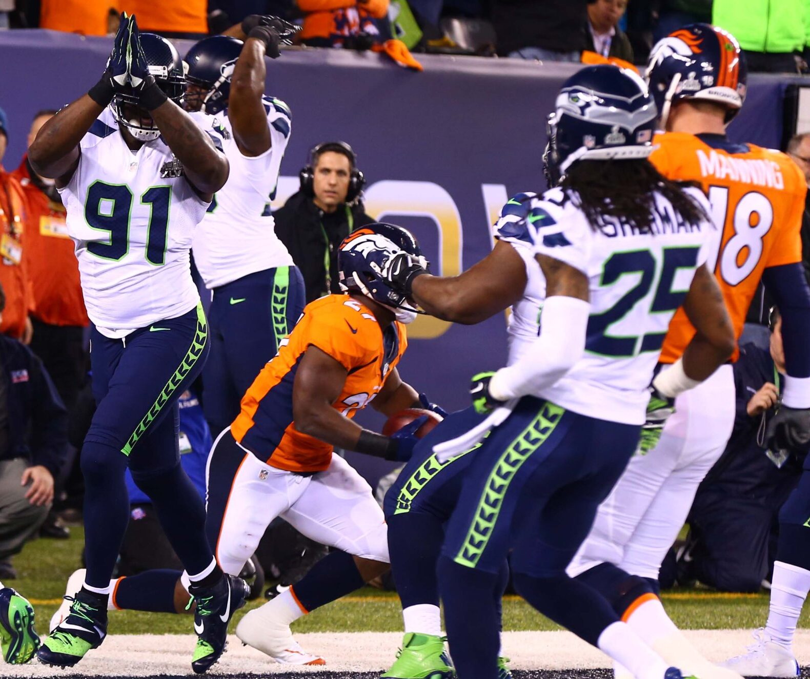 Seattle Seahawks defensive end Chris Clemons (91) celebrates with teammates after a safety in the first quarter against the Denver Broncos in Super Bowl XLVIII