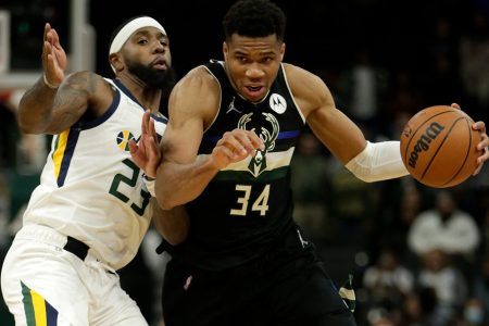 Giannis Antetokounmpo #34 of the Milwaukee Bucks dribbles past Royce O'Neale #23 of the Utah Jazz during the second half of a game at Fiserv Forum on October 31, 2021 in Milwaukee, Wisconsin.