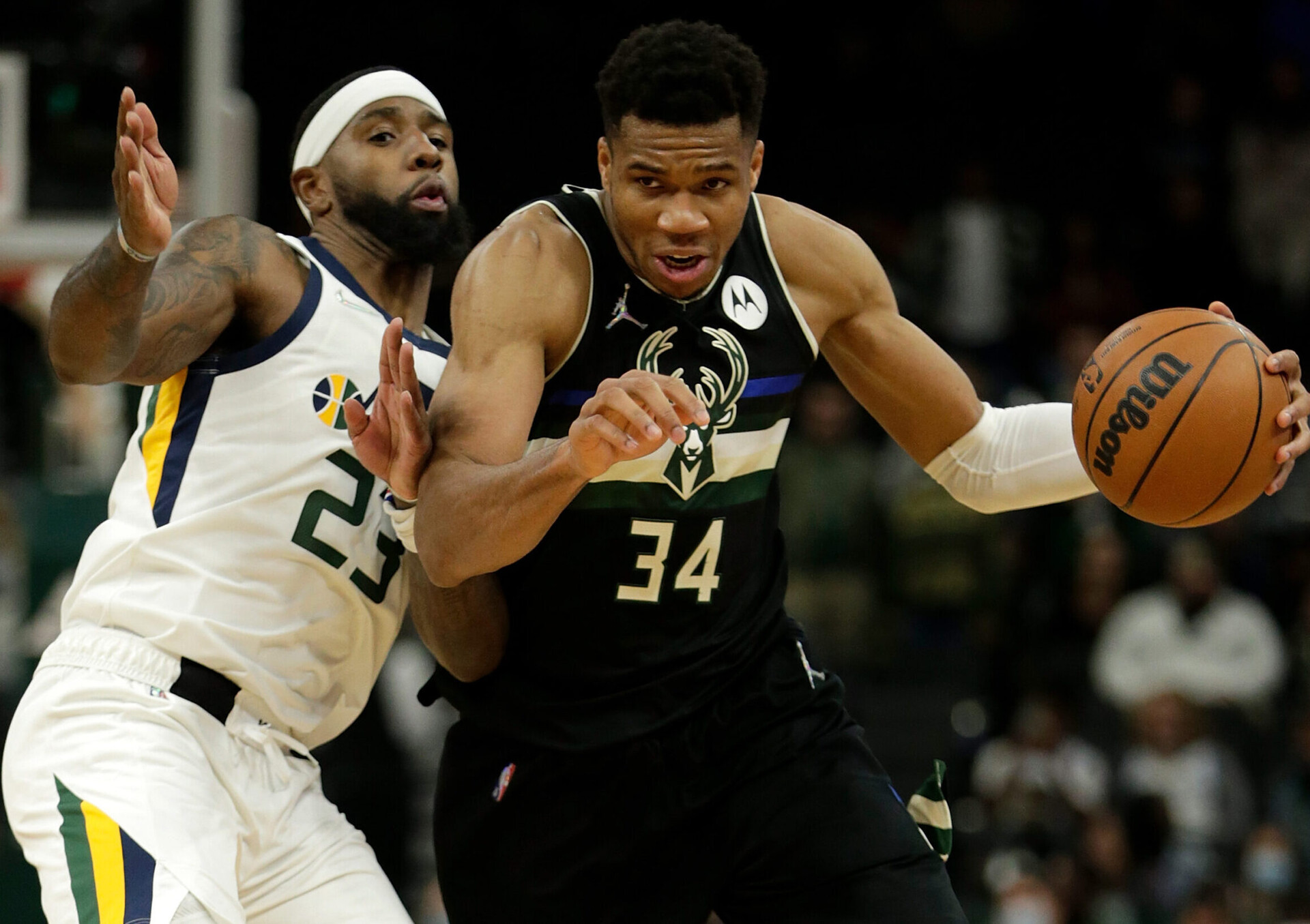 Giannis Antetokounmpo #34 of the Milwaukee Bucks dribbles past Royce O'Neale #23 of the Utah Jazz during the second half of a game at Fiserv Forum on October 31, 2021 in Milwaukee, Wisconsin.