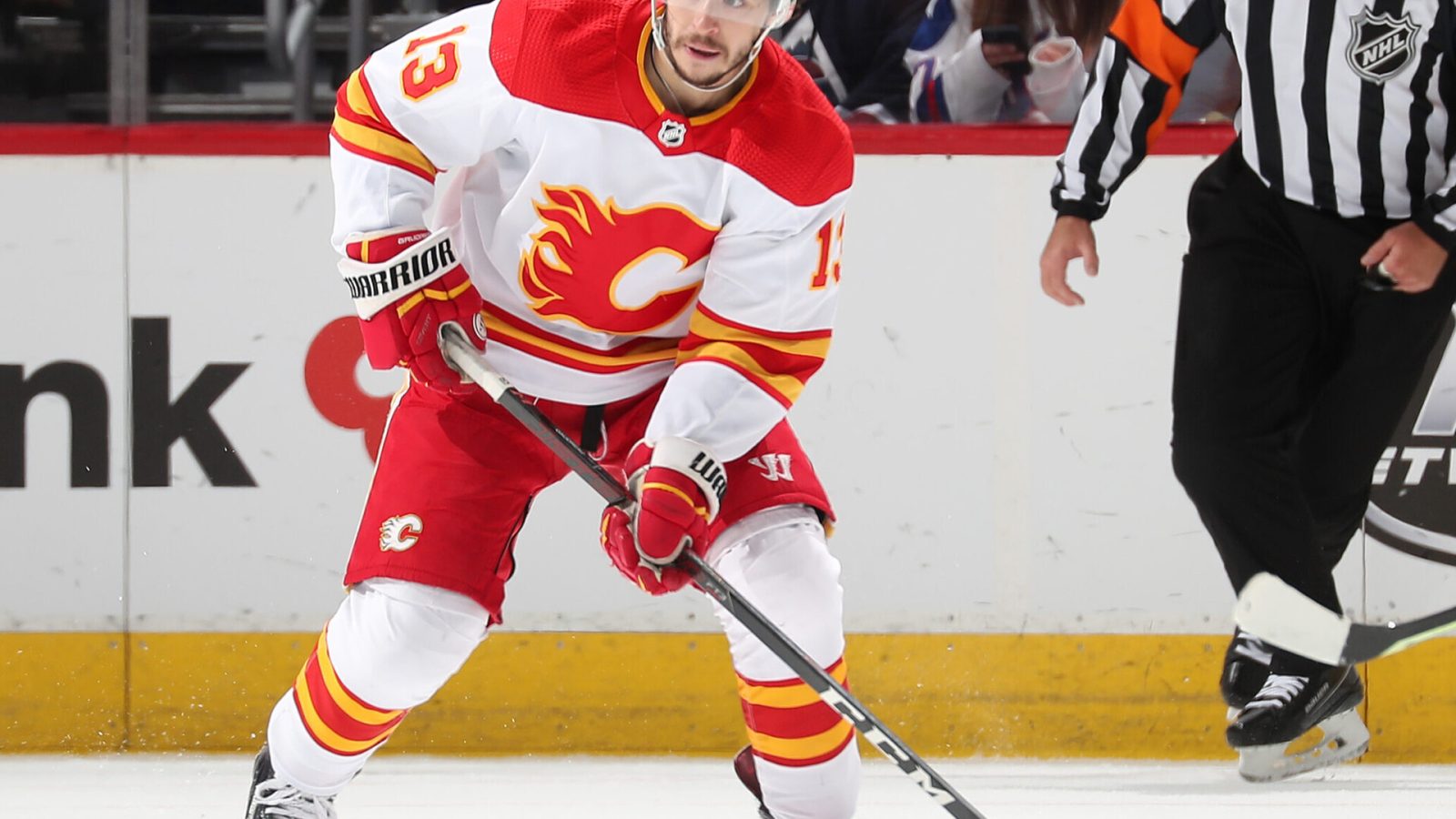 Johnny Gaudreau #13 of the Calgary Flames skates with the puck against the Colorado Avalanche at Ball Arena