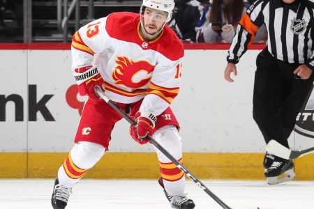 Johnny Gaudreau #13 of the Calgary Flames skates with the puck against the Colorado Avalanche at Ball Arena