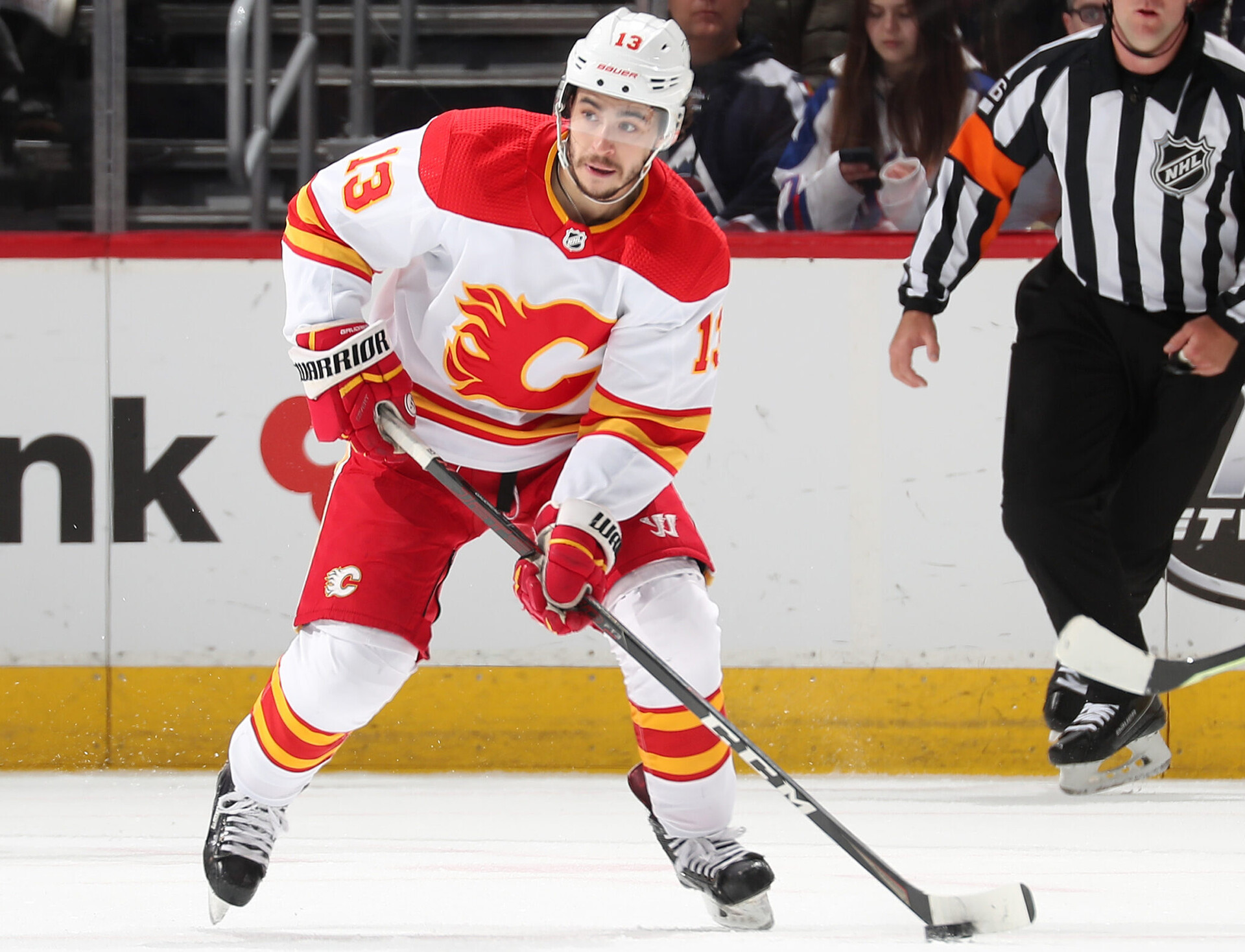Johnny Gaudreau #13 of the Calgary Flames skates with the puck against the Colorado Avalanche at Ball Arena