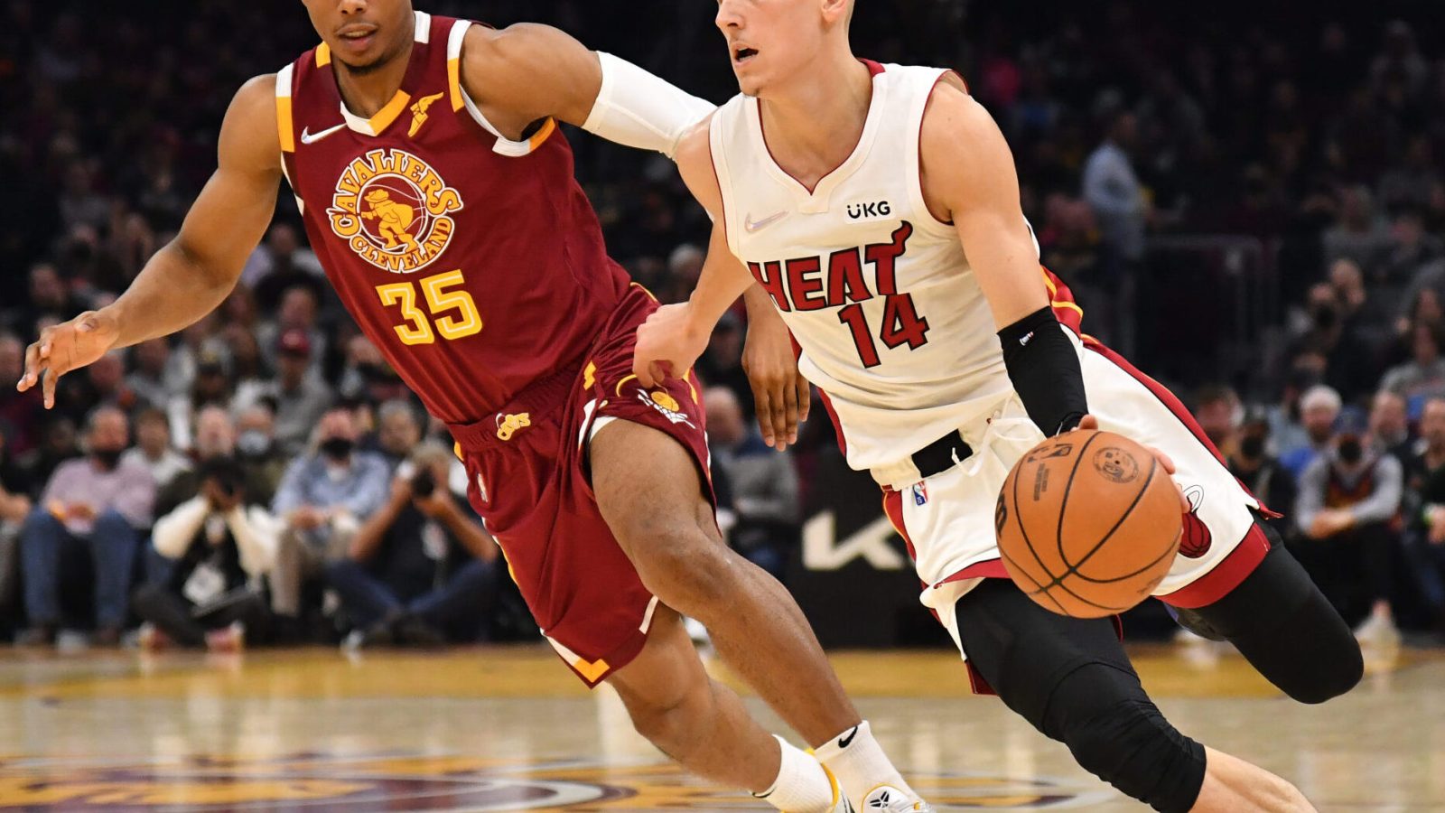 Tyler Herro #14 of the Miami Heat drives to the basket around Isaac Okoro #35 of the Cleveland Cavaliers during the second quarter at Rocket Mortgage Fieldhouse on December 13, 2021 in Cleveland, Ohio.