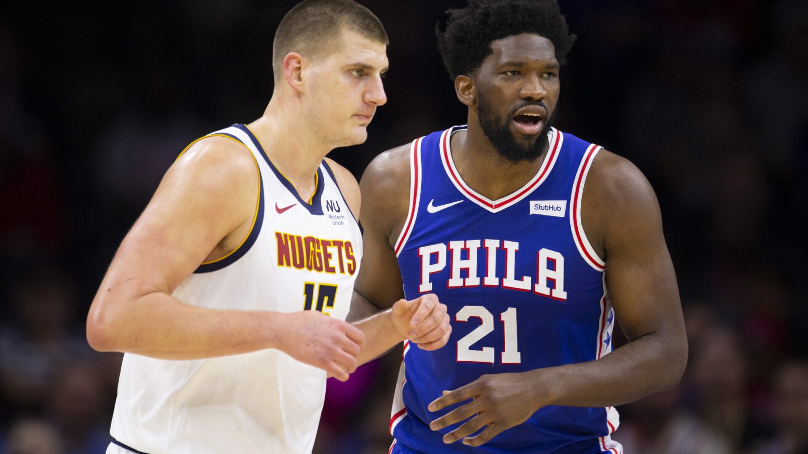 Joel Embiid #21 of the Philadelphia 76ers guards Nikola Jokic #15 of the Denver Nuggets in the first quarter at the Wells Fargo Center on December 10, 2019 in Philadelphia, Pennsylvania. The 76ers defeated the Nuggets 97-92.