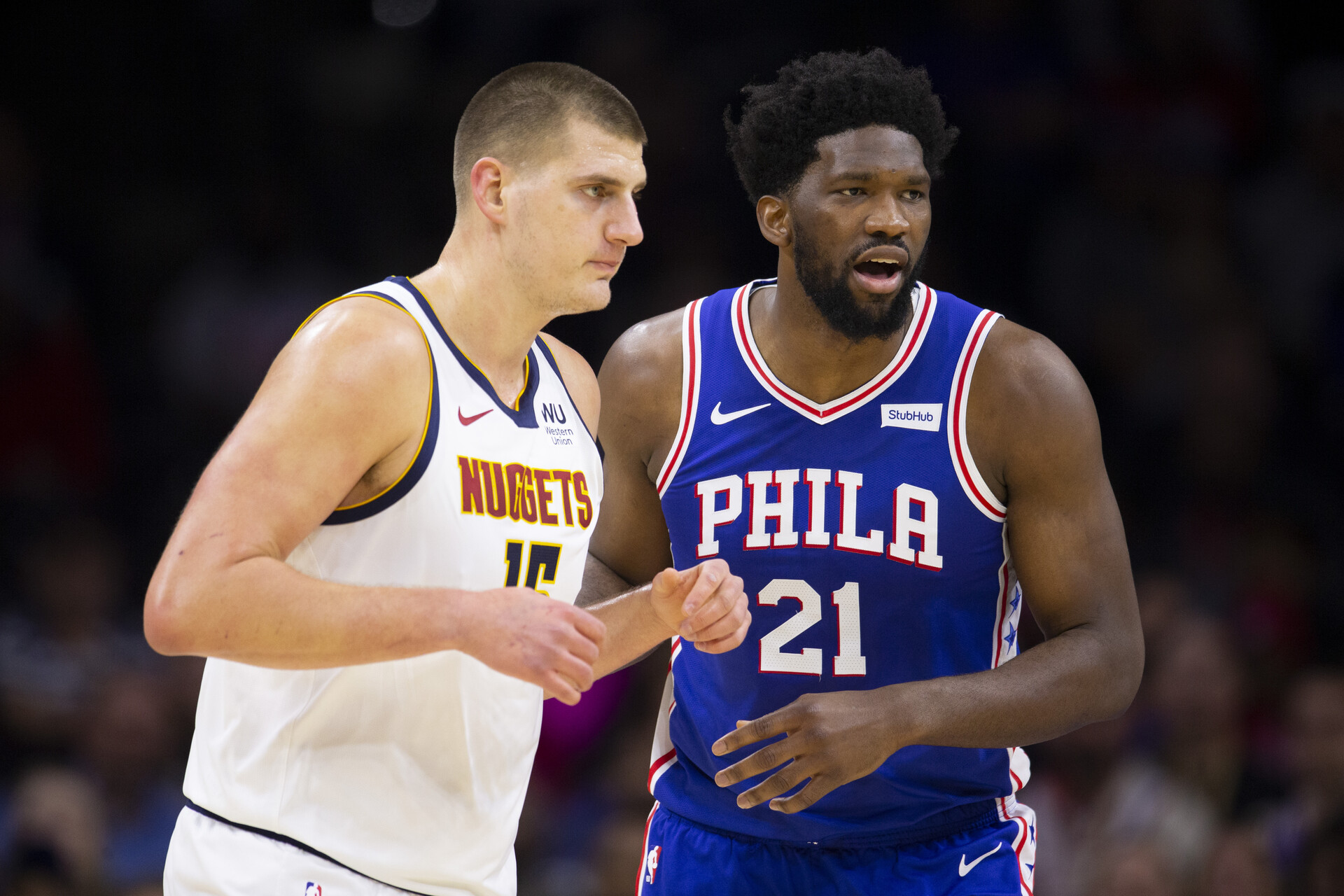 Joel Embiid #21 of the Philadelphia 76ers guards Nikola Jokic #15 of the Denver Nuggets in the first quarter at the Wells Fargo Center on December 10, 2019 in Philadelphia, Pennsylvania. The 76ers defeated the Nuggets 97-92.