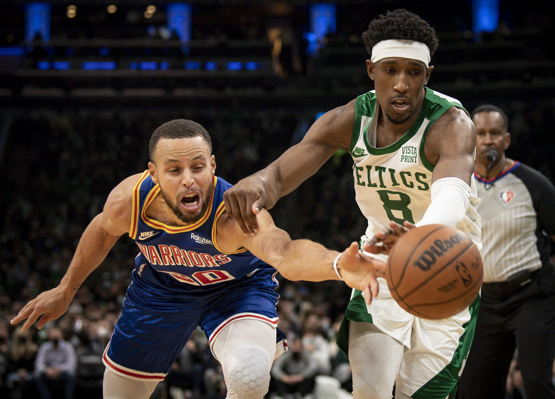 Golden State Warriors guard Stephen Curry (left) and Boston Celtics player Josh Richardson (right) both reach for a loose ball
