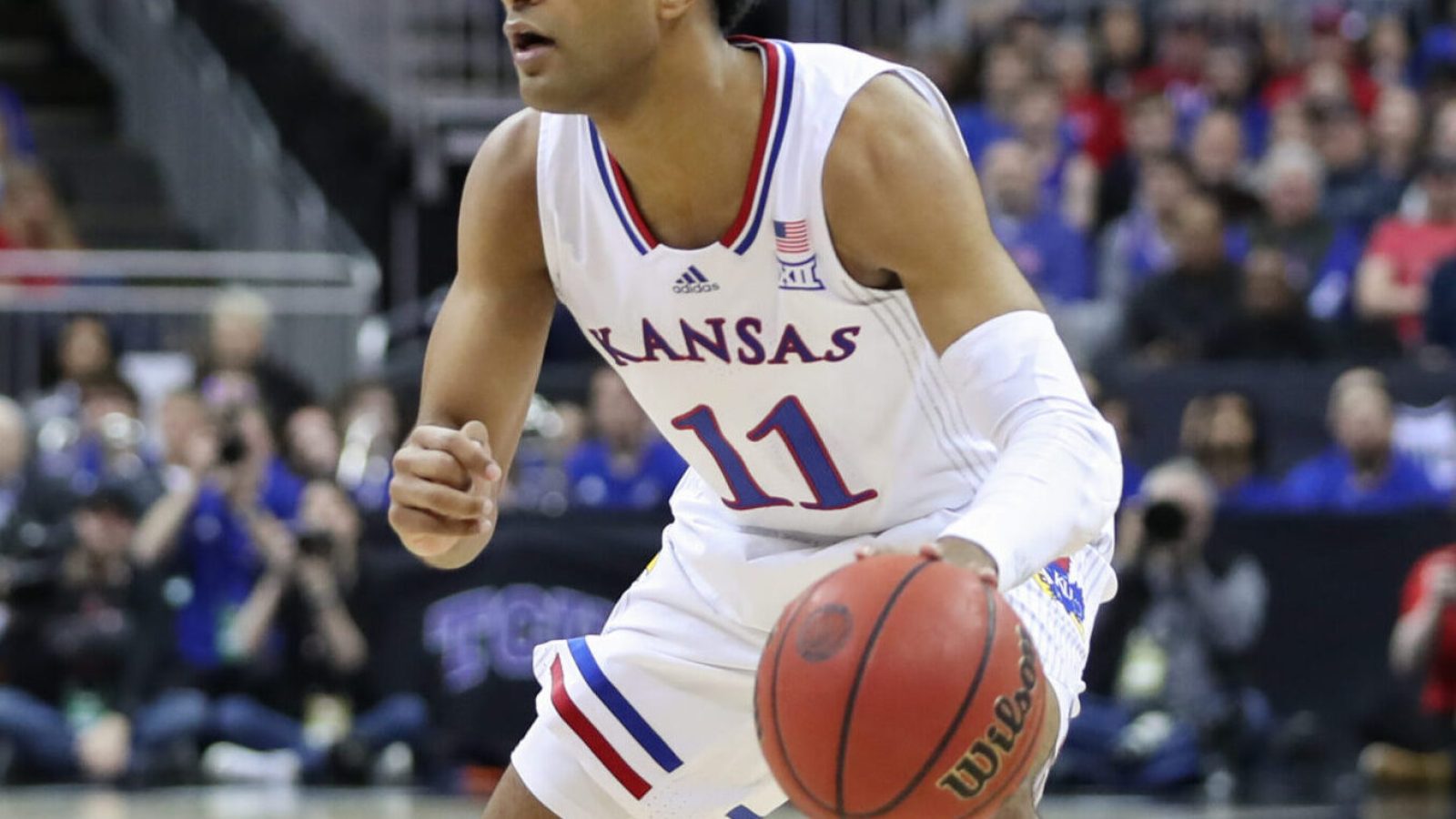 Kansas Jayhawks guard Remy Martin (11) with the ball in the first half of the Big 12 Tournament championship game between the Texas Tech Red Raiders and Kansas Jayhawks on Mar 12, 2022 at T-Mobile Arena in Kansas City, MO.
