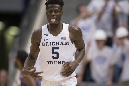 Gideon George #5 of the Brigham Young Cougars reacts after making a three-point basket against the Northern Iowa Panthers during the first half of their second round NIT game March 19, 2022 at the Marriott Center in Provo, Utah.
