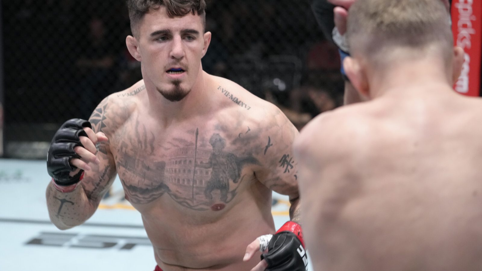 Tom Aspinall of England (right) looks to land a punch with his right hand against Serghei Spivak of the Ukraine in their welterweight fight during UFC Fight Night