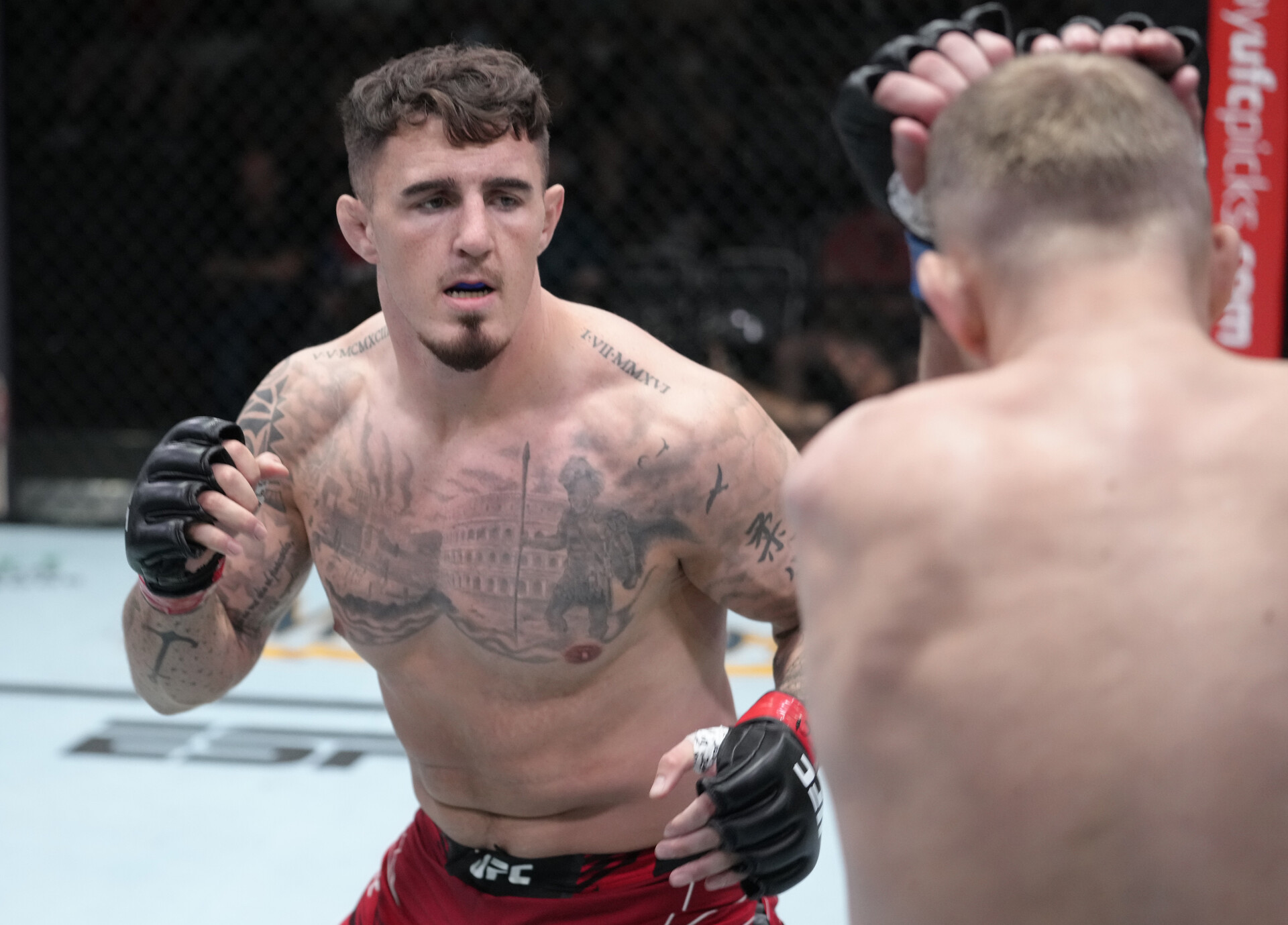 Tom Aspinall of England (right) looks to land a punch with his right hand against Serghei Spivak of the Ukraine in their welterweight fight during UFC Fight Night