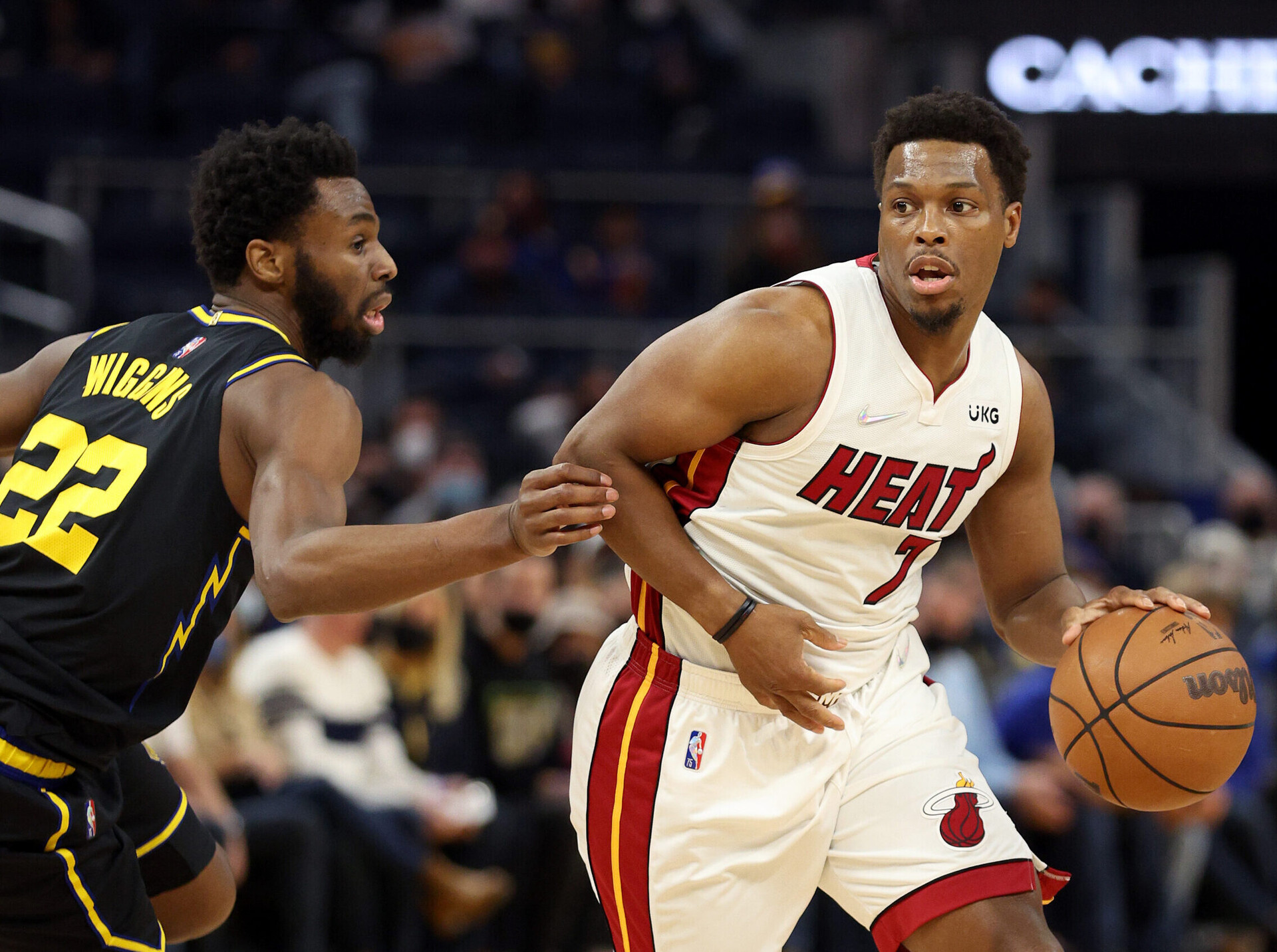 Kyle Lowry #7 of the Miami Heat is guarded by Andrew Wiggins #22 of the Golden State Warriors at Chase Center on January 03, 2022 in San Francisco, California